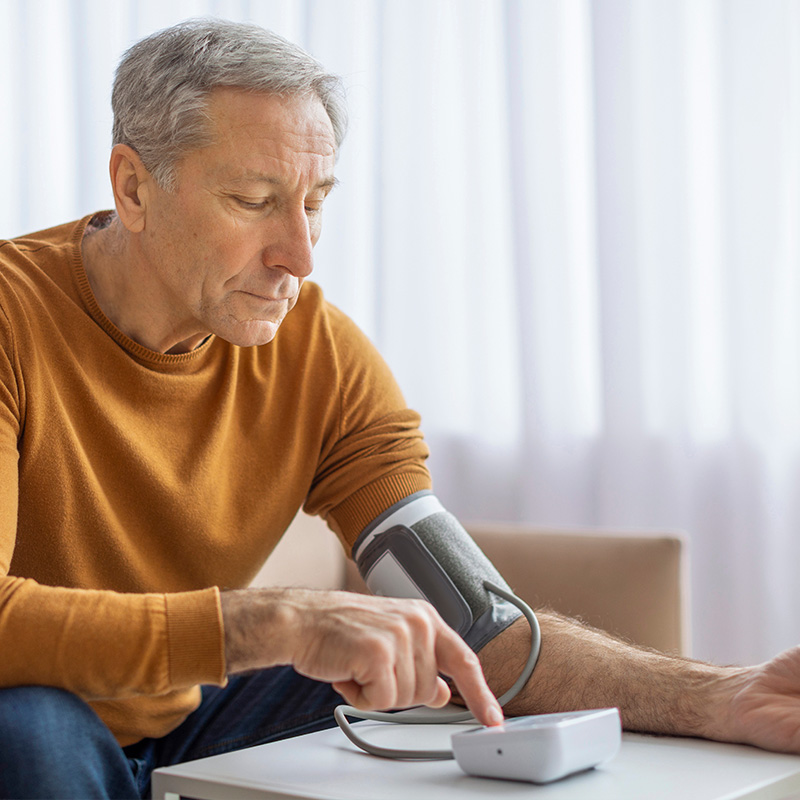 elderly man checking blood pressure